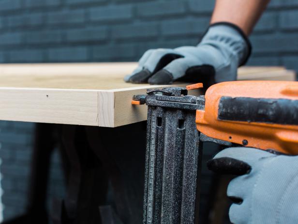 With hammer and nails attach trim to the plywood edges. Attach the shorter pieces first and make sure the edge is flush , then add the longer pieces.