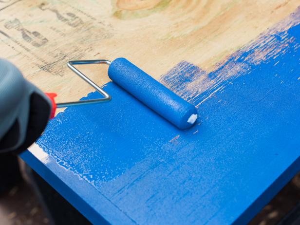 Next, paint the entire game top out in a solid blue exterior paint. This not only looks good, it protects the wood from elements like heat and moisture, so make it sure you use a good quality paint