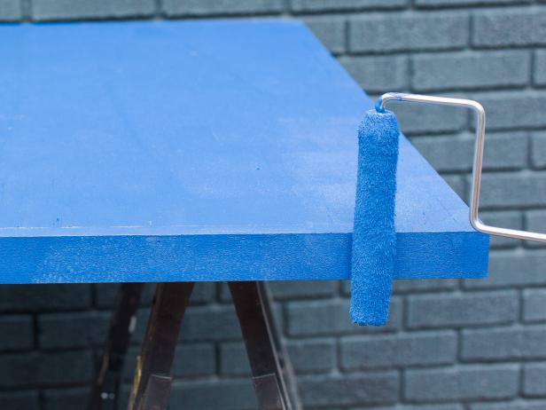 Next, paint the entire game top out in a solid blue exterior paint. This not only looks good, it protects the wood from elements like heat and moisture, so make it sure you use a good quality paint