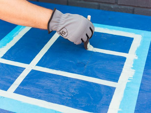 Next, with a lighter paint- we used aqua, using the 6 inch and 14 inch marks as a guide, free hand lines with 1” foam paint brush to create the grid. It’s okay if they’re not perfect, that’s part of the handmade charm! Once dry, remove the tape