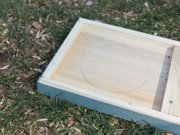 Trace a circle to accommodate your particular ice bucket. To get started with your cut, you’ll need to use a drill with a large bit to make a pilot hole, then insert your jig blade and cut the hole out. Cut the circle out just inside the traced line so that ice bucket fits snug.