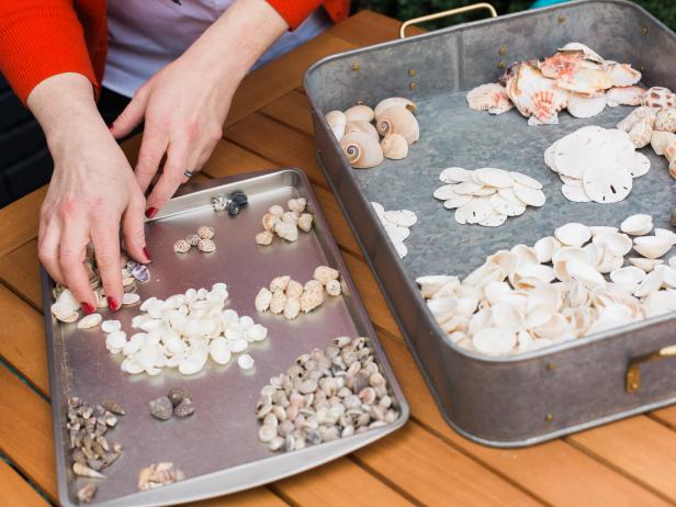 To keep costs down, buy shells in assortment packs-any craft store carries them. Sort them before you start, grouping like shells together as it’ll be easier to create designs on the urn using one type of shell at a time.