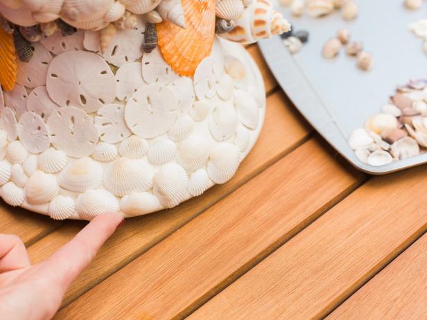 Once the urn is largely covered, fill in the nooks and crannies and camouflage any wayward globs of hot glue with the smaller shells. This is the main reason we suggest going with a neutral colored urn- if there are spaces that show through when you’re finished they won’t be that obvious to the naked eye! Also, the smaller shells are useful as you get close to the top edge of the urn.