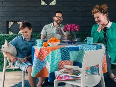 Vibrant colors, fun patterns and durable seating transform an unused outdoor space into the perfect spot for a young family to dine together al fresco. When decorating a family-friendly outdoor space, consider low-maintenance furnishings, soft underfoot surfaces and durable seating options.