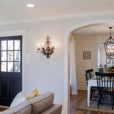Archway Connected Living and Dining Space With Hardwood Flooring and Light Neutral Color Scheme 