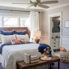 Gorgeous Country Wood Headboard, Royal Blue Bed Accents and Large Area Rug in Neutral Bedroom 