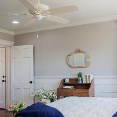 Neutral Country Bedroom With Split Wall design, White Ceiling Fan and Blue Accent Bed Covers