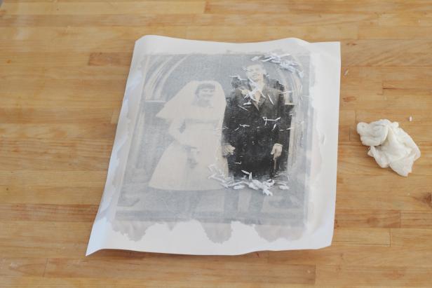 Step 4: Use the cloth to lightly scrub the paper away revealing the image underneath. Continue to add water and lightly scrub until all of the paper is gone.