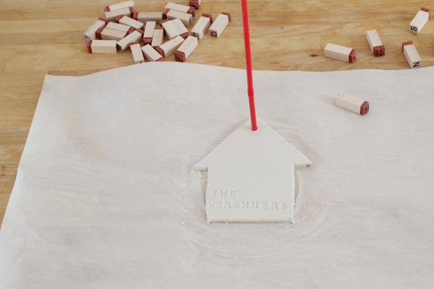 Step 5: Use the straw to create a hole at the top for the twine.