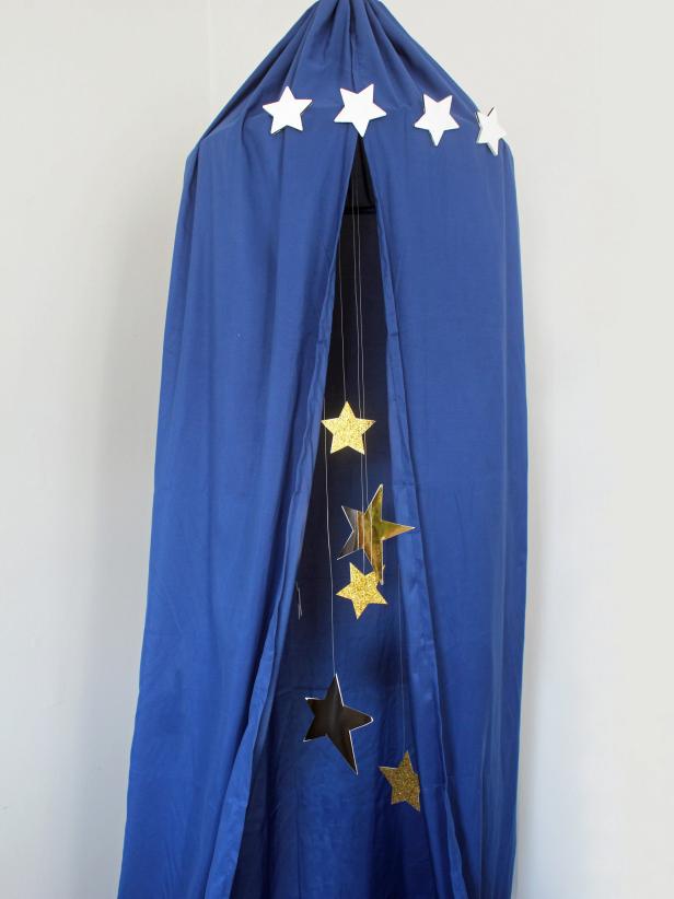 This magical night sky canopy is a simple, no-sew project to make on a rainy day. Using materials readily found in your local big box store, you can create a special place for your child to read books, relax and play with toys. Best of all, this project is easy on the wallet and doable for novice DIYers.