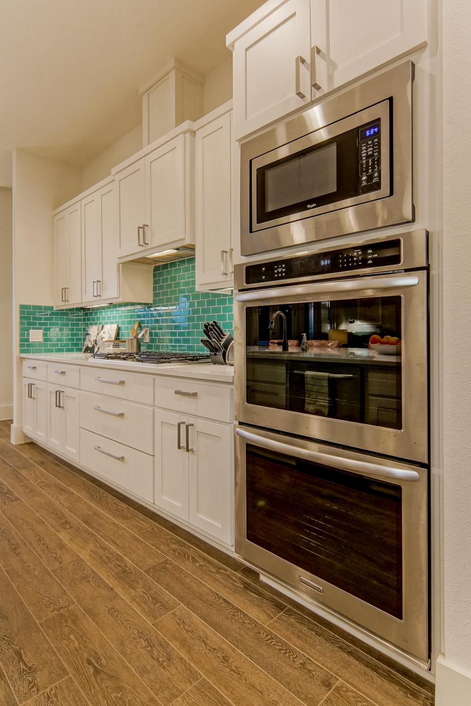 Modern White Kitchen With Teal Backsplash White Kitchen With Teal Backsplash and Hardwood Floors