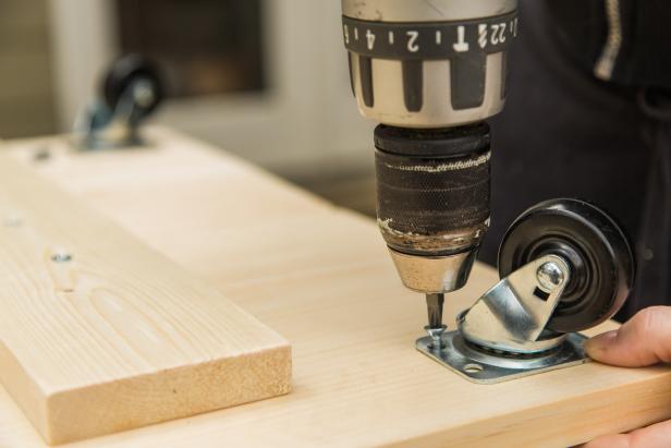 While the base is still flipped upside down, install the casters on each corner. First, measure and mark for placement- 1 inch from each edge. Next, fasten using #10 1” wood screws.