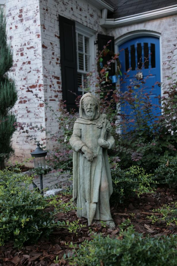 A statute of St. Fiacre – the patron saint of gardeners – holds a prominent spot in the front of the English cottage. Behind the home, the garden has smaller sculptures of St. Fiacre and St. Francis, the patron saint of nature. “You need all the help you can get,” Katie Sanstead said.
