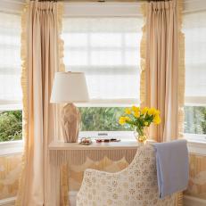 Elegant Window Desk Set Up With Ruffle Trimmed Curtains, Gold Patterned Armchair and Yellow Tulips