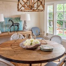Natural Wood Table, White Wicker Chairs and Driftwood Lamps in Coastal Dining Room 