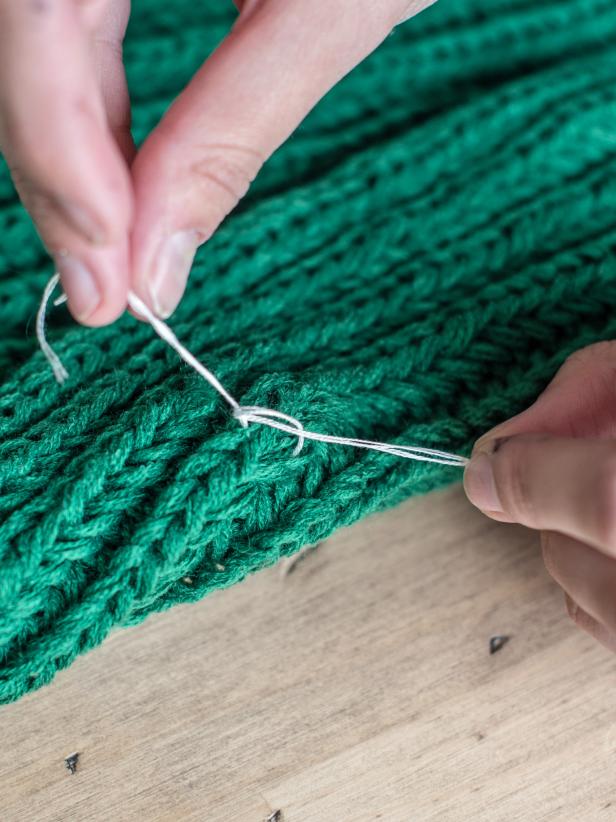 Step 2: Sew Buttons to ScarfCut a length of floss about 12-18 inches long and section out two threads. Thread length embroidery floss onto needle. Pull through scarf and button, allowing end of thread to remain on back of scarf. Insert needle through second buttonhole and tie two ends behind scarf. Repeat with other buttonholes until button is secured. Knot and trim thread. Repeat with other buttons, arranging in pattern to shape each letter.