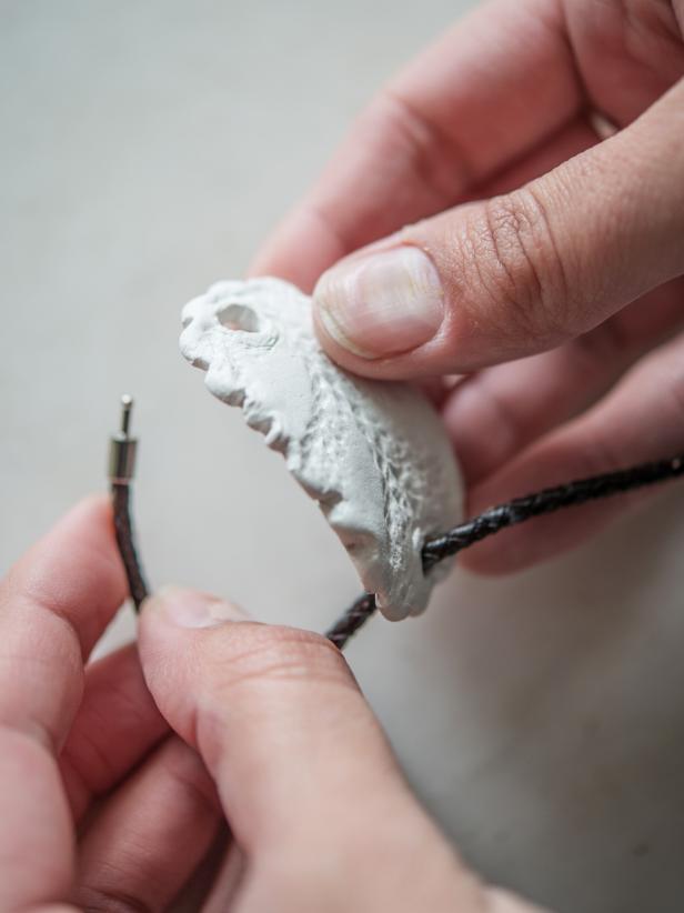Step 6: Thread Bracelet/Ribbon Through ClayTo make this new creation wearable, thread it onto a leather bracelet with a clasp or even use a simple ribbon or length of twine. Tip: If opening isnât large enough, gently sand away clay until itâs the proper size.