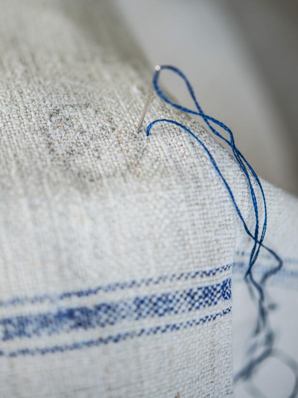 Step 3: Cross-stitch MonogramCreate X-shaped stitches on each square naturally created in the weave of the linen, following selected cross-stitch pattern. It is helpful if the fabric is starched or inserted in an embroidery hoop, so it is taut. Pull each stitch, so it is snug, but not too tight. Tip: Since this is a towel that can be seen from both sides, keep in mind how the back will look. Large pieces of thread running across the back have the potential of getting snagged.