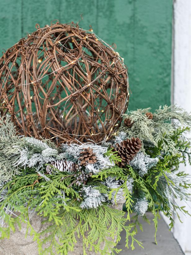 For simple, but high impact arrangement for a porch or entryway, try these lighted grapevine spheres.  They are a great way to fill urns that have been left empty once the summer and fall flowers fade.