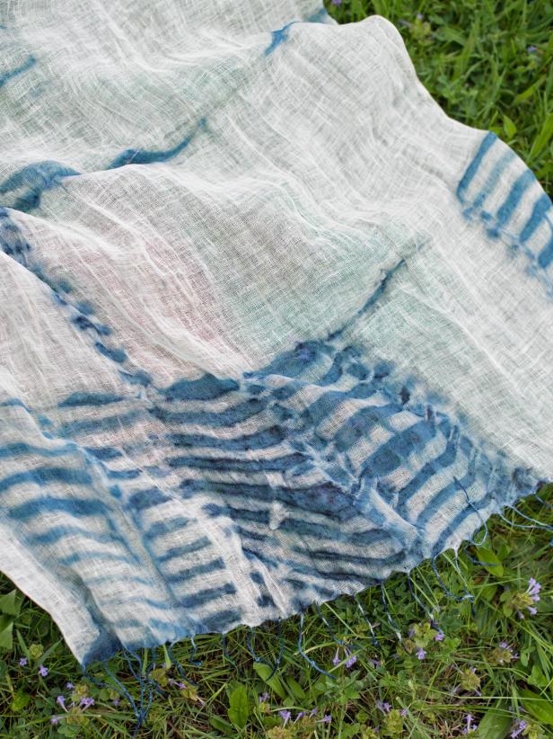 Step 4: Undo ResistsRemove resists (rubber bands, popsicle sticks, etc.) from scarf. Unfold fabric and hang or lay out to dry. Some of the fabric may again appear green until it is exposed to the air.