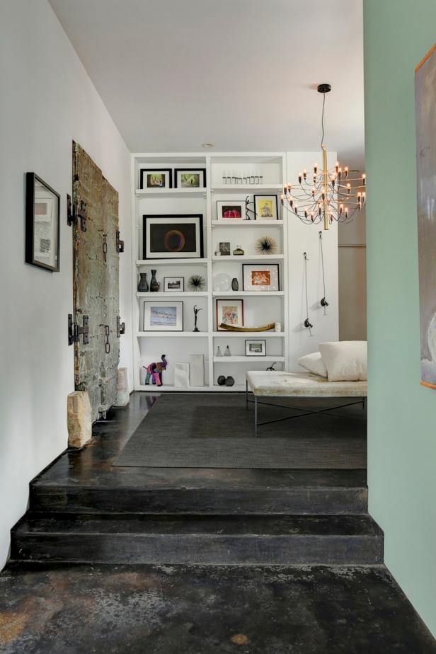 Contemporary Hallway With Artsy Shelf Display, Antique Double Doors and Black Stone Flooring Contemporary White Hall