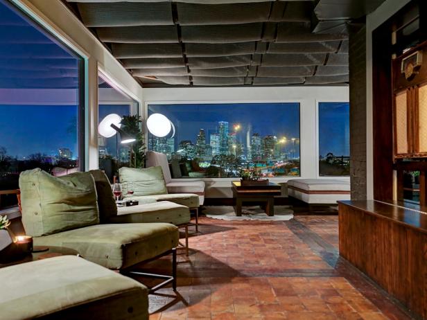 dim stylish dining area with skyline view plush green chairs and red stone flooring - Hgtv Dining Room dim stylish dining area with skyline view plush green chairs and red stone flooring - Hgtv Dining Room