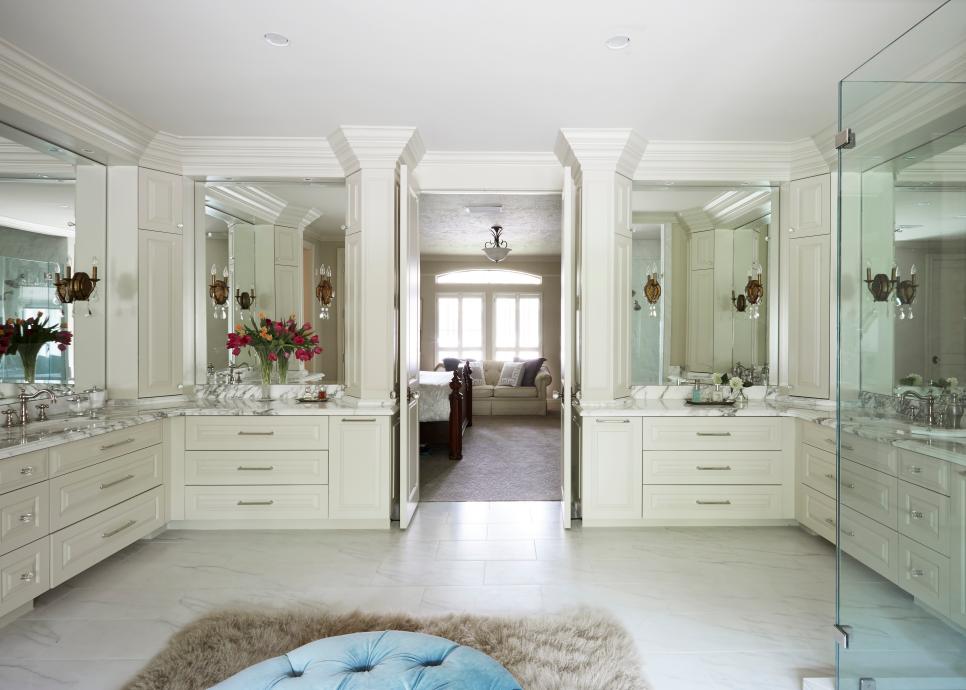 Spacious Double Vanity Master Bathroom With Built In Cream Cabinets, White Marble Floor and Large Vanity MIrrors Neutral Traditional Master Bathroom