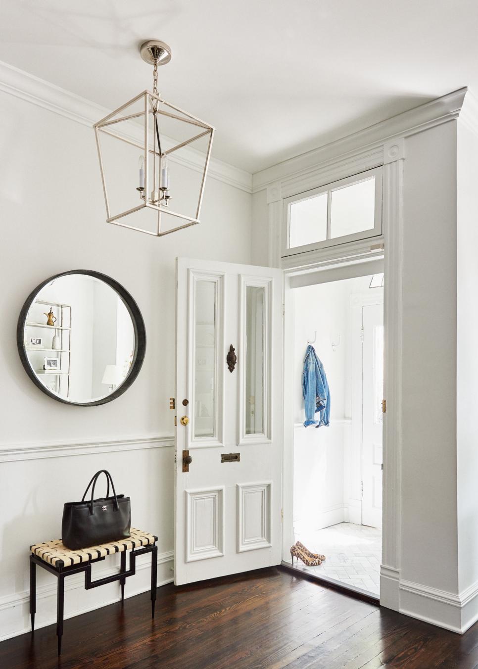 Classic Entryway is Stunningly White Traditional White Foyer With Hardwood Floor