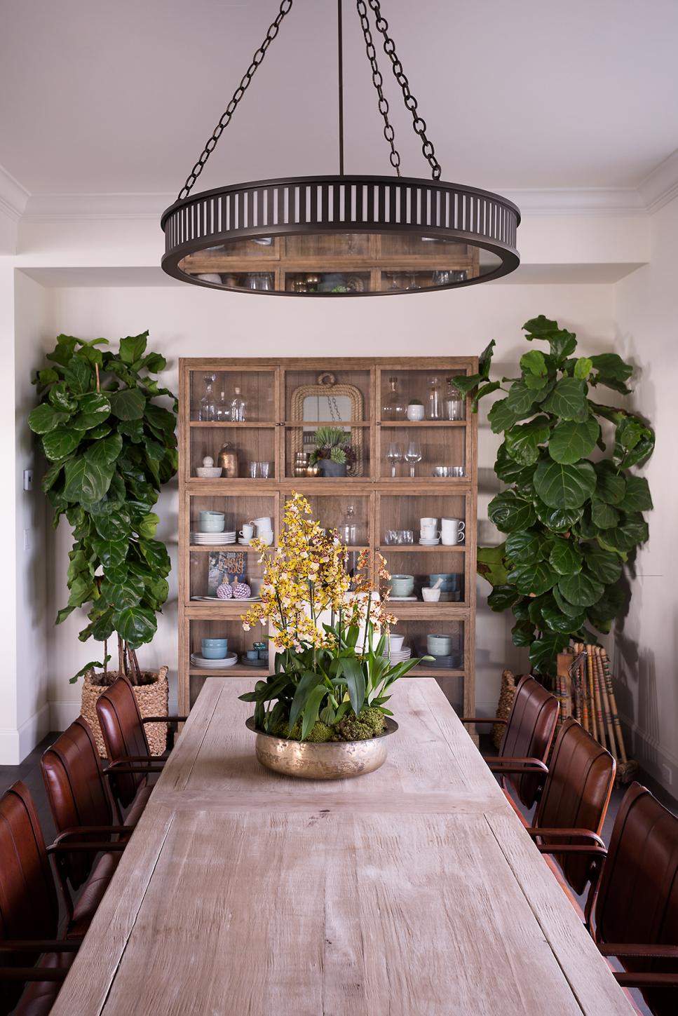 Rustic Dining Room With Leather Chairs Round Chandelier in Rustic Dining Room