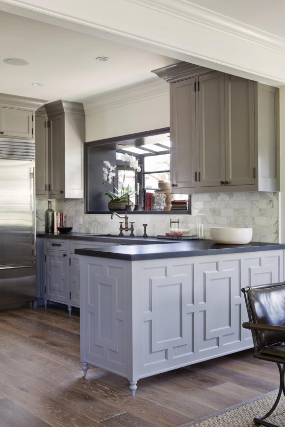 Kitchen With White Cabinets and Marble Tile Backsplash