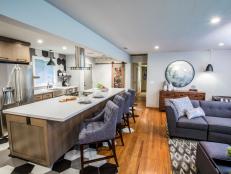 As seen on America’s Most Desperate Kitchens, this renovated Sacramento, California kitchen features matching octogonal wall and floor tiles, stainless appliances and an eat in counter with upholstered stools. (After)