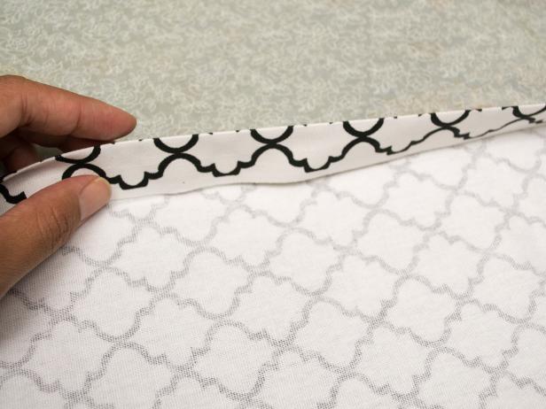 Fold in the edges again one inch and press down with an iron then pin them in place.