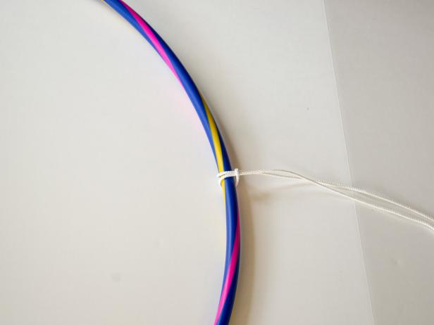 Pull the tails of the rope up through the loop of the rope and pull to tighten.
