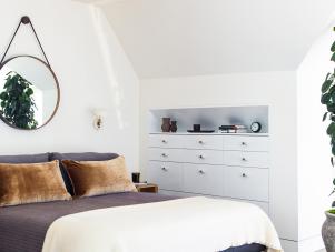 White Contemporary Master Bedroom With Round Mirror