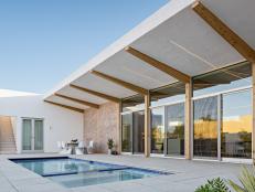 Pool With Concrete Patio and Exposed Beam Overhang