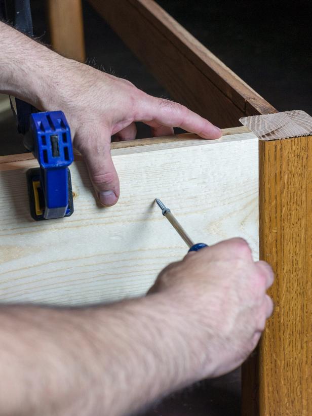 Cut 1âx 8â boards to length to wrap around the table. If the legs stick out further than the sides, cut the boards to fit between the legs. Secure them with wood screws
