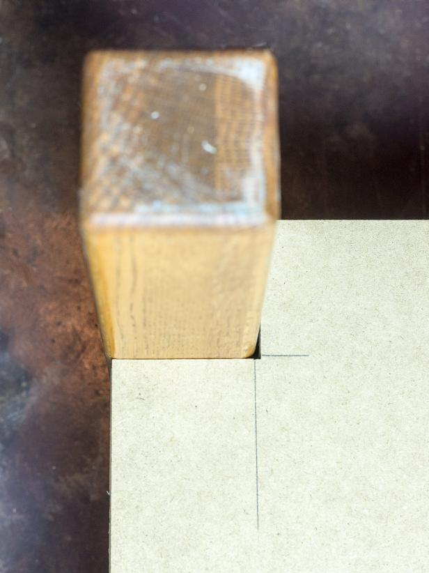 Cut a piece of 1/2" MDF to fit the bottom of your ottoman including the side. You may need to make notches on the corners to accommodate the legs