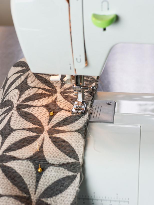 Remove any excess. Measure the sides of your ottoman with the batting. Cut upholstery fabric adding 6â to the height of each side and 1â to the length of each side. Lay the pieces together with the good sides of the fabric facing each other. Sew each corner together with a 1/2" seam allowance. Be sure to alternate long ends and short ends, so the seams line up at the corners.
