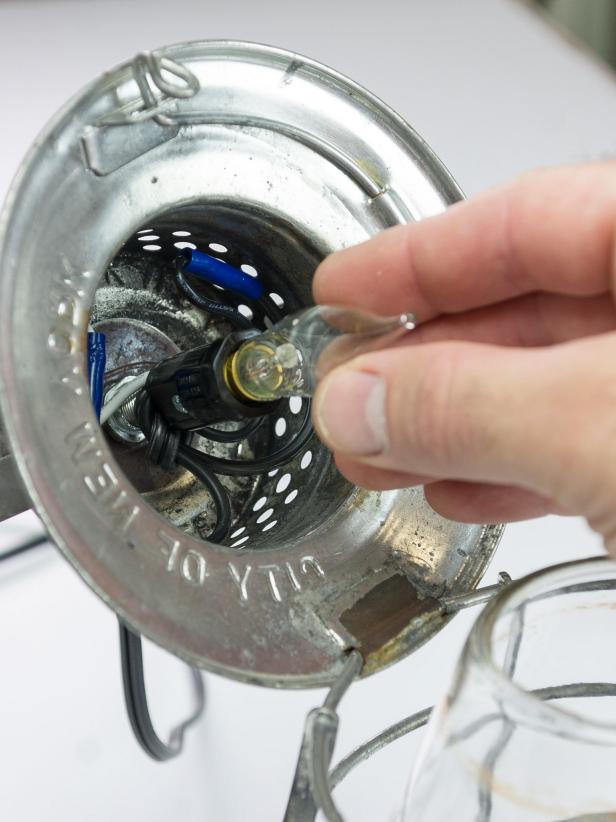 Add the flange to the wall to cover the box and wires using 1â wood screws. Add a candelabra bulb to the socket. Alternatively, if you do not wish to hard wire your lantern, leave the plug on the extension cord. Hang your lantern from a hook and plug in to the wall socket. Add a candelabra bulb to the socket.