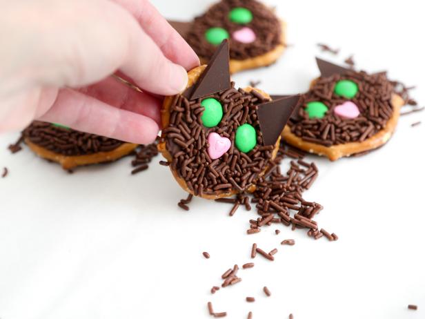 When the chocolate is set, pick up each pretzel and tap away the excess chocolate sprinkles.