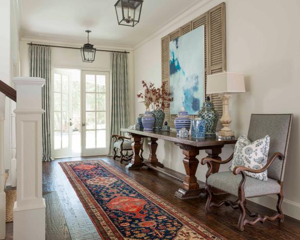 White French Door Access to Traditional Foyer With Gray Upholstered Chairs, Patterned Carpet Runner and Lantern Pendant Lights White French Door Access to Traditional Foyer With Gray Upholstered Chairs, Patterned Carpet Runner and Lantern Pendant Lights