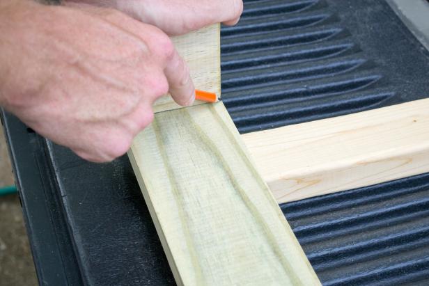 Mark the location of the legs on the front and rear upper (48 inch) leg supports. Mark a ¾ inch margin at each end, and along the top edge from the ends inward 4 inches.