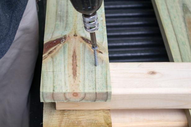 Attach two legs to the front upper leg support using two-inch exterior screws.