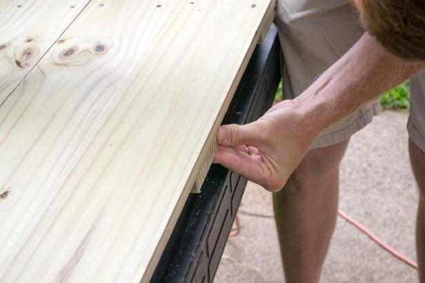 Line up the 22 ¾ inch 1x4’s to the inside of the two-inch and 14-inch lines.