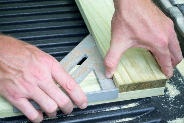 Attach the 48 inch arm of the tool rack to the ends of the two 24 inch uprights using 1 ½ inch screws.