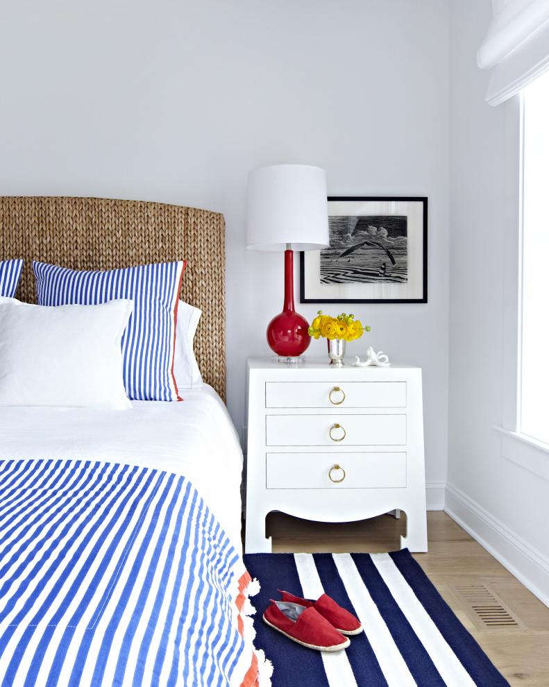White Coastal Bedroom With Red and Blue Accents