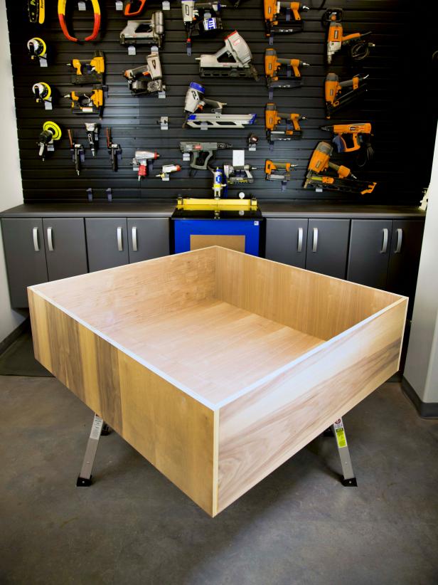 Lay piece A on the ground, and glue and nail two B pieces to opposite sides of piece A from the outside of the box. Piece B should not be resting on piece A. Wipe away any glue drips on plywood face while glue is still wet.