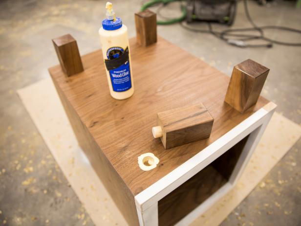 Glue and align legs in holes in bottom of console ensuring legs are parallel with edges of box.
