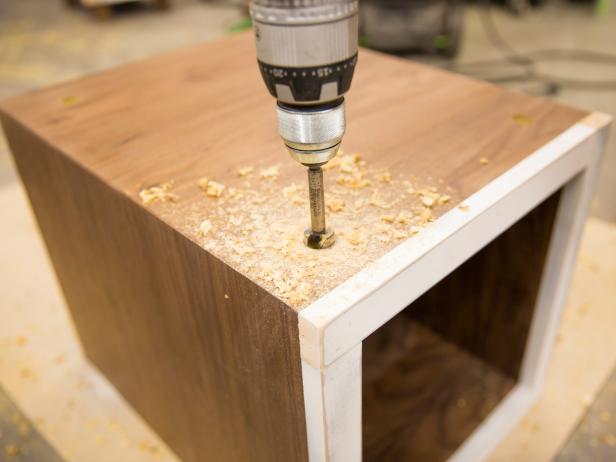 Measure and mark center line for all console legs at 2 1/2" off the edges. Drill a 3/4" deep hole with 7/8" Forstner bit at each location.