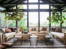 This backyard retreat provides a bevy of space for entertaining, from a plush screened porch with cushy seating to a two car garage that mimics the Craftsman design of the main house. 